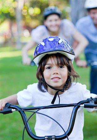 simsearch:400-05755734,k - Adorable little boy riding a bike in a park Photographie de stock - Aubaine LD & Abonnement, Code: 400-04197017