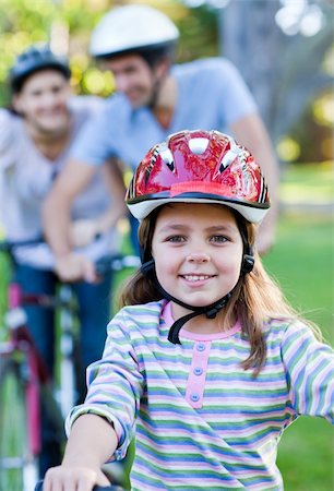 simsearch:400-05755734,k - Smiling little girl riding a bike in a park Photographie de stock - Aubaine LD & Abonnement, Code: 400-04197019