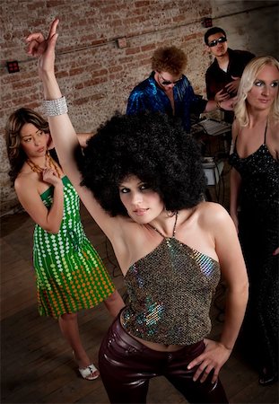 simsearch:400-04206686,k - Pretty girl with afro wig at a 1970s Disco Music Party Stock Photo - Budget Royalty-Free & Subscription, Code: 400-04197148