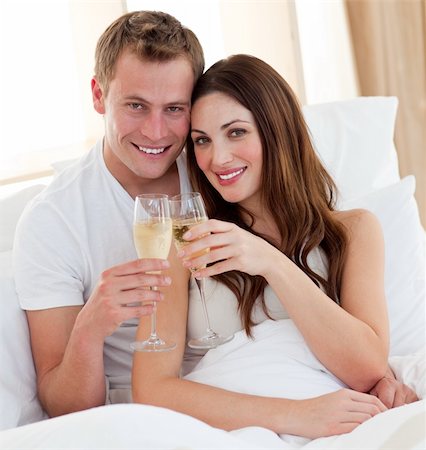 simsearch:400-04195864,k - Loving couple drinking champagne lying in bed at home Stock Photo - Budget Royalty-Free & Subscription, Code: 400-04197308