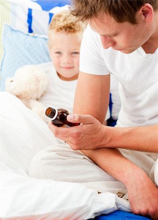 feeble - Concerned man looking after his sick son lying in his bed Stock Photo - Budget Royalty-Free & Subscription, Code: 400-04197443