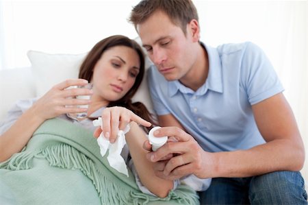 simsearch:400-05716904,k - Attentive husband looking after his wife in the living-room Stock Photo - Budget Royalty-Free & Subscription, Code: 400-04197589