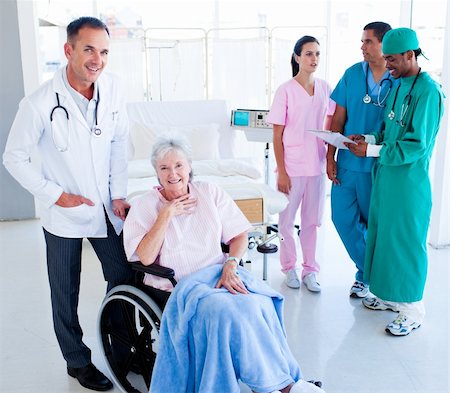 Positive medical team taking care of a senior woman at hospital Stock Photo - Budget Royalty-Free & Subscription, Code: 400-04198256