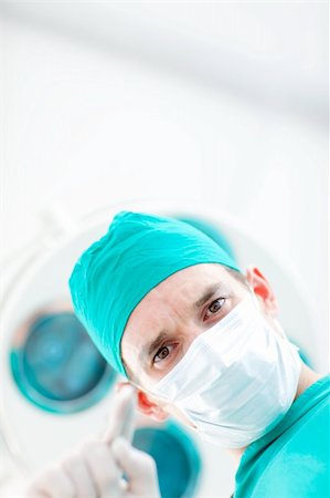 simsearch:400-05717937,k - Portrait of a confident surgeon during a surgery Stock Photo - Budget Royalty-Free & Subscription, Code: 400-04198374