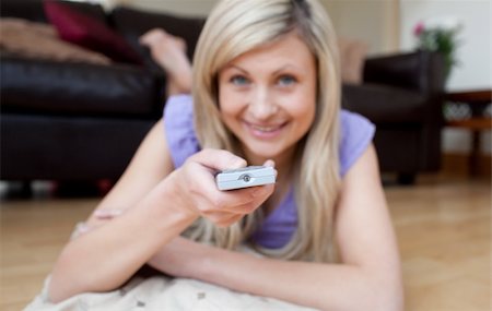 simsearch:400-04210845,k - Cheerful woman watching TV lying on the floor in the living-room Stock Photo - Budget Royalty-Free & Subscription, Code: 400-04198712