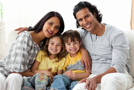 simsearch:400-04193348,k - Lively family watching TV together sitting on a sofa at home Stock Photo - Budget Royalty-Free & Subscription, Code: 400-04198775