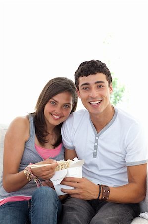 simsearch:400-04199223,k - Couple of teenagers eating pasta at home on the sofa with copy-space Stock Photo - Budget Royalty-Free & Subscription, Code: 400-04199161