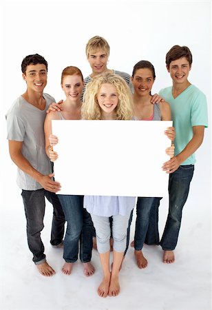 simsearch:400-04199223,k - Group of teenagers holding a blank card agaisnt white background Stock Photo - Budget Royalty-Free & Subscription, Code: 400-04199181