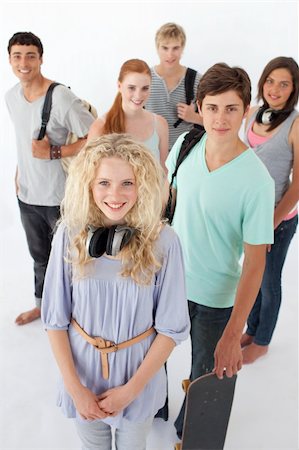 simsearch:400-04199223,k - Happy teenagers smiling at the camera agaisnt white background with bags Stock Photo - Budget Royalty-Free & Subscription, Code: 400-04199196