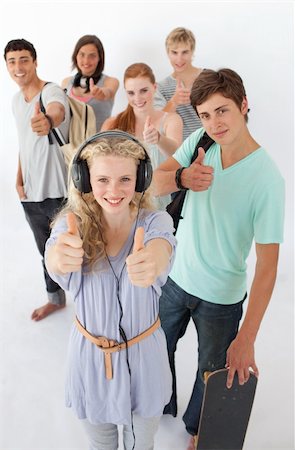 simsearch:400-04199223,k - Happy teenagers smiling at the camera agaisnt white background Stock Photo - Budget Royalty-Free & Subscription, Code: 400-04199198