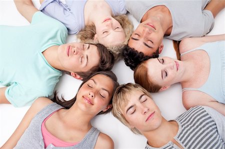 simsearch:400-04199223,k - Teens sleeping on floor with heads together in a circle Stock Photo - Budget Royalty-Free & Subscription, Code: 400-04199205
