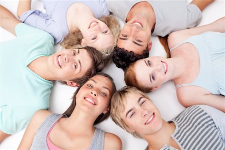 simsearch:400-04199223,k - Teens relaxing on floor with heads together in a circle Stock Photo - Budget Royalty-Free & Subscription, Code: 400-04199207