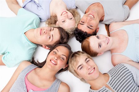 simsearch:400-04199223,k - Friends relaxing on floor with heads together in a circle Stock Photo - Budget Royalty-Free & Subscription, Code: 400-04199203