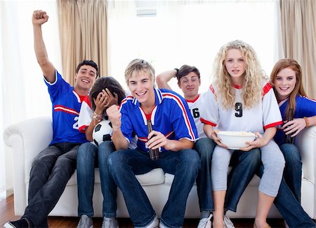 simsearch:400-04199223,k - Group of excited and happy teenagers watching a football match in the living-room Stock Photo - Budget Royalty-Free & Subscription, Code: 400-04199213