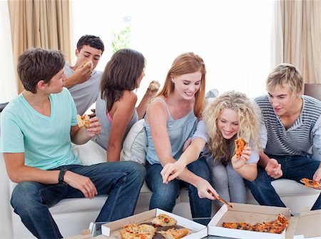simsearch:400-04199223,k - Six teenagers eating pizza in the living-room on the sofa Stock Photo - Budget Royalty-Free & Subscription, Code: 400-04199223