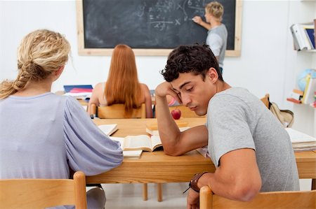 Tired young teenager getting bored in a class Stock Photo - Budget Royalty-Free & Subscription, Code: 400-04199240