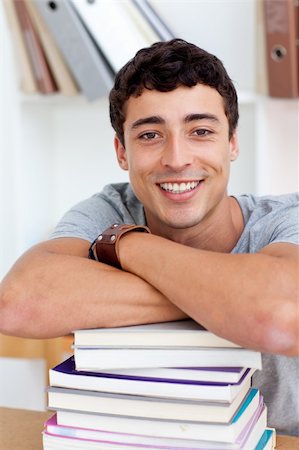 Smiling teeenager studying lots of books in the library Stock Photo - Budget Royalty-Free & Subscription, Code: 400-04199289