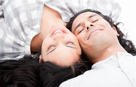 simsearch:400-04195864,k - Smiling couple relaxing on the floor against a white background Stock Photo - Budget Royalty-Free & Subscription, Code: 400-04190044