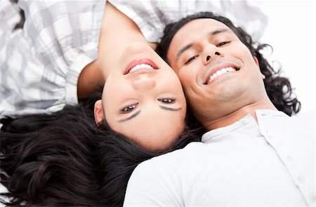 simsearch:400-04195864,k - Laughing couple relaxing on the floor against a white background Stock Photo - Budget Royalty-Free & Subscription, Code: 400-04190046