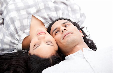 simsearch:400-04195864,k - Pretty couple relaxing on the floor against a white background Stock Photo - Budget Royalty-Free & Subscription, Code: 400-04190042