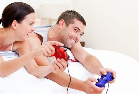 simsearch:400-04195864,k - Joyful couple playing video games against a white background Stock Photo - Budget Royalty-Free & Subscription, Code: 400-04190104