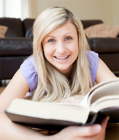 simsearch:400-04206778,k - Smiling woman reading a book in the living-room Foto de stock - Super Valor sin royalties y Suscripción, Código: 400-04190789