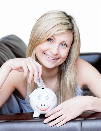 simsearch:400-04184165,k - Delighted woman using a piggybank against a white background Stock Photo - Budget Royalty-Free & Subscription, Code: 400-04190837