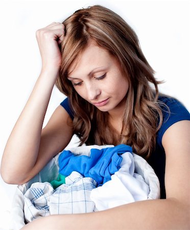 simsearch:400-08693600,k - Unhappy woman doing laundry isolated on a white background Stock Photo - Budget Royalty-Free & Subscription, Code: 400-04192015