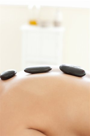 simsearch:400-04192083,k - Caucasian woman lying on a massage table having a stone therapy Stock Photo - Budget Royalty-Free & Subscription, Code: 400-04192065