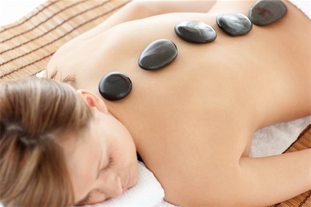 simsearch:400-04192063,k - Bright woman lying on a massage table having a stone therapy Stock Photo - Budget Royalty-Free & Subscription, Code: 400-04192060
