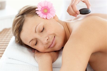 simsearch:400-04192063,k - Portrait of a radiant woman having a flower on a massage table Stock Photo - Budget Royalty-Free & Subscription, Code: 400-04192098