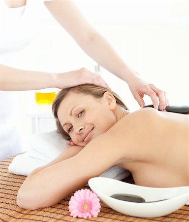 simsearch:400-04192063,k - Portrait of a confident woman having a massage with stones at the spa Stock Photo - Budget Royalty-Free & Subscription, Code: 400-04192111