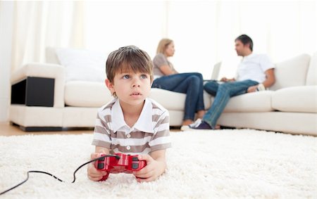 simsearch:400-05751526,k - Cute little boy playing video games lying on the floor Stock Photo - Budget Royalty-Free & Subscription, Code: 400-04193255