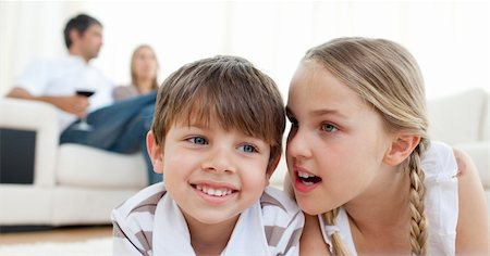 simsearch:400-04193348,k - Little girl telling a secret to her brother lying on the floor Stock Photo - Budget Royalty-Free & Subscription, Code: 400-04193352