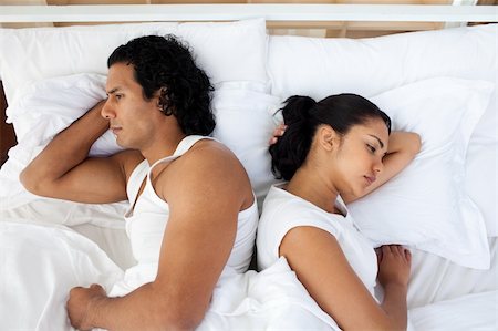 Upset couple lying in the bed after having an argument Stock Photo - Budget Royalty-Free & Subscription, Code: 400-04193481