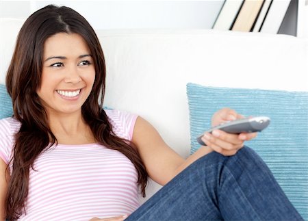 simsearch:400-04210845,k - Happy Caucasian woman watching TV sitting on a sofa Stock Photo - Budget Royalty-Free & Subscription, Code: 400-04204078