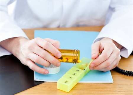 simsearch:6109-06005907,k - Close-up of a doctor giving pills to a patient in a practice Stock Photo - Budget Royalty-Free & Subscription, Code: 400-04204092