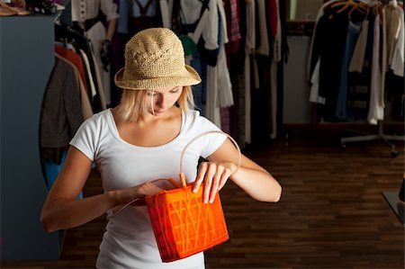 young woman searching her handbag in a boutique Stock Photo - Budget Royalty-Free & Subscription, Code: 400-04204575