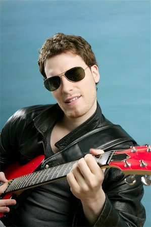 picture of the blue playing a instruments - sexy rock man sunglasses and leather black jacket over blue Stock Photo - Budget Royalty-Free & Subscription, Code: 400-04204910