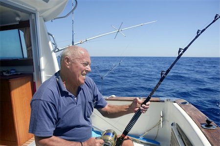 Angler elderly big game sport fishing boat blue summer sea sky Stock Photo - Budget Royalty-Free & Subscription, Code: 400-04205479