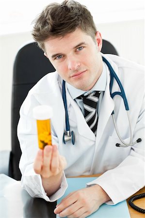 simsearch:6109-06005907,k - Beautiful doctor holding pills in his office Stock Photo - Budget Royalty-Free & Subscription, Code: 400-04205545