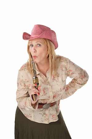 Woman with pink cowboy hat with a recently used pistol Stock Photo - Budget Royalty-Free & Subscription, Code: 400-04205703