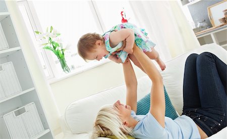 Merry mother playing with her daughter in living room Stock Photo - Budget Royalty-Free & Subscription, Code: 400-04206214