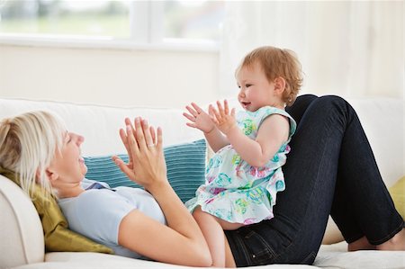 Attractive mother playing with her daughter in living room Stock Photo - Budget Royalty-Free & Subscription, Code: 400-04206254