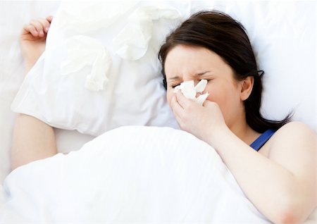 feeble - Sick young woman using a tissue lying in a bed at home Foto de stock - Super Valor sin royalties y Suscripción, Código: 400-04206750
