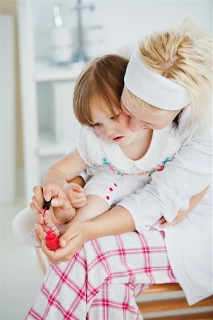 Concentrated mother playing with her daughter in bathroom Stock Photo - Budget Royalty-Free & Subscription, Code: 400-04206865