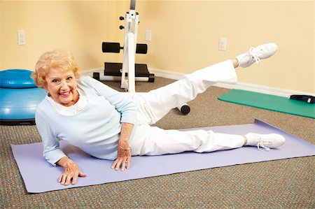 fitness   mature woman - Fit happy senior woman doing stretching exercises on her yoga mat. Stock Photo - Budget Royalty-Free & Subscription, Code: 400-04208633