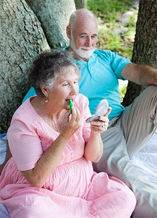 simsearch:400-04208630,k - Senior woman on a picnic in the park applies lip balm with sunscreen. Stock Photo - Budget Royalty-Free & Subscription, Code: 400-04208908