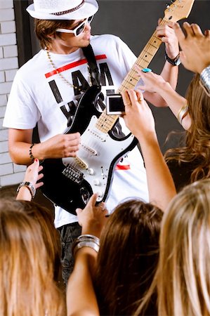 reaching for the stars - A guitarist performing for his adoring fans at disco club or party Stock Photo - Budget Royalty-Free & Subscription, Code: 400-04209083