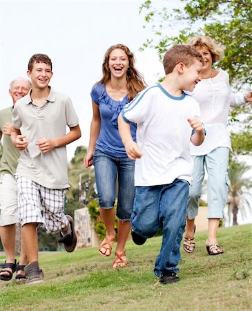 simsearch:400-07426233,k - Happy young family chasing young kid in the park and having fun Stock Photo - Budget Royalty-Free & Subscription, Code: 400-04209136